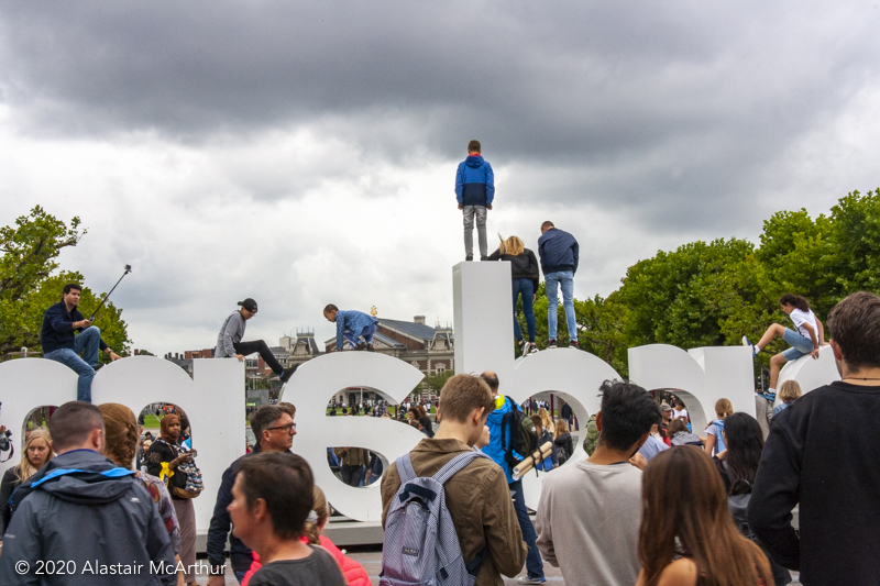 Tourists climbing on the Amsterdam sign. Amsterdam 2016. 