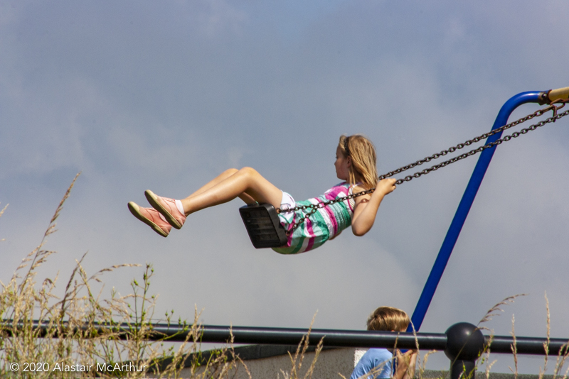 Playing on a swing. Blackwaterfoot, Arran. 2013.